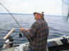 Reggie Gebo reeling in a 24 pound Laker. Click to enlarge picture.
