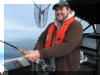 Kevin Duby reeling in a Lake Trout